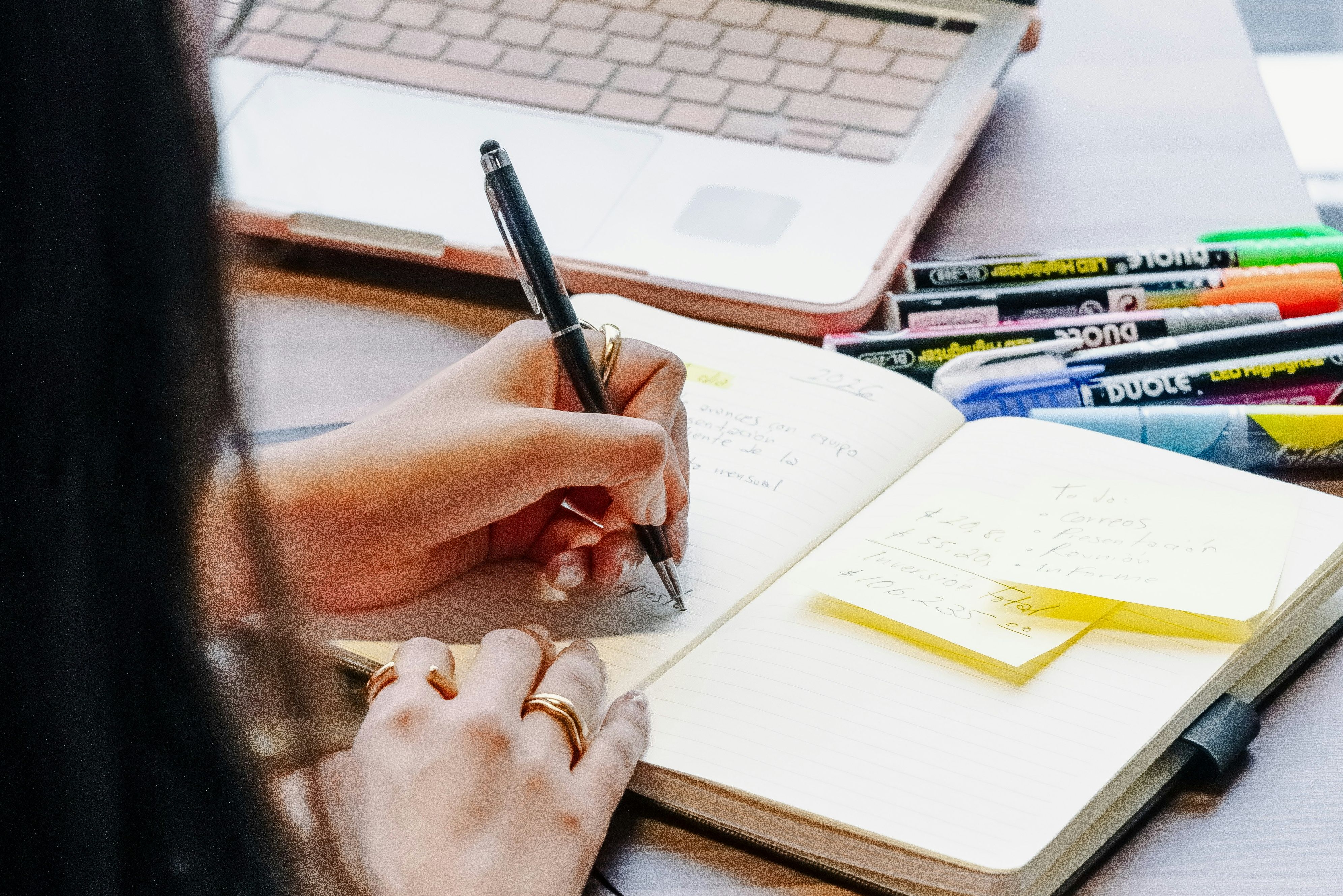 A woman writing intentions in her journal